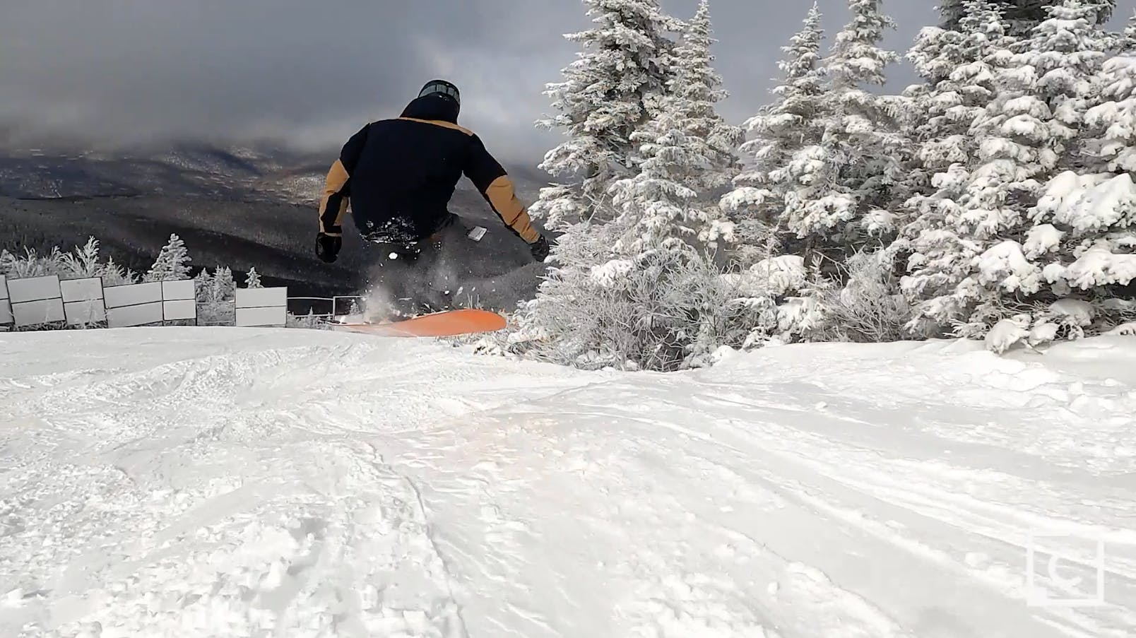 Curated expert Colby Henderson jumping through the air on the Never Summer Harpoon snowboard