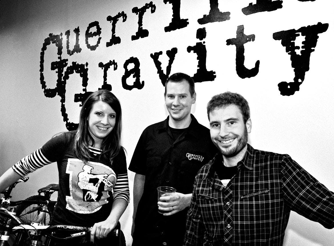 A black and white photo of the three people who make up Guerrilla Gravity's founding team - two men and a woman.