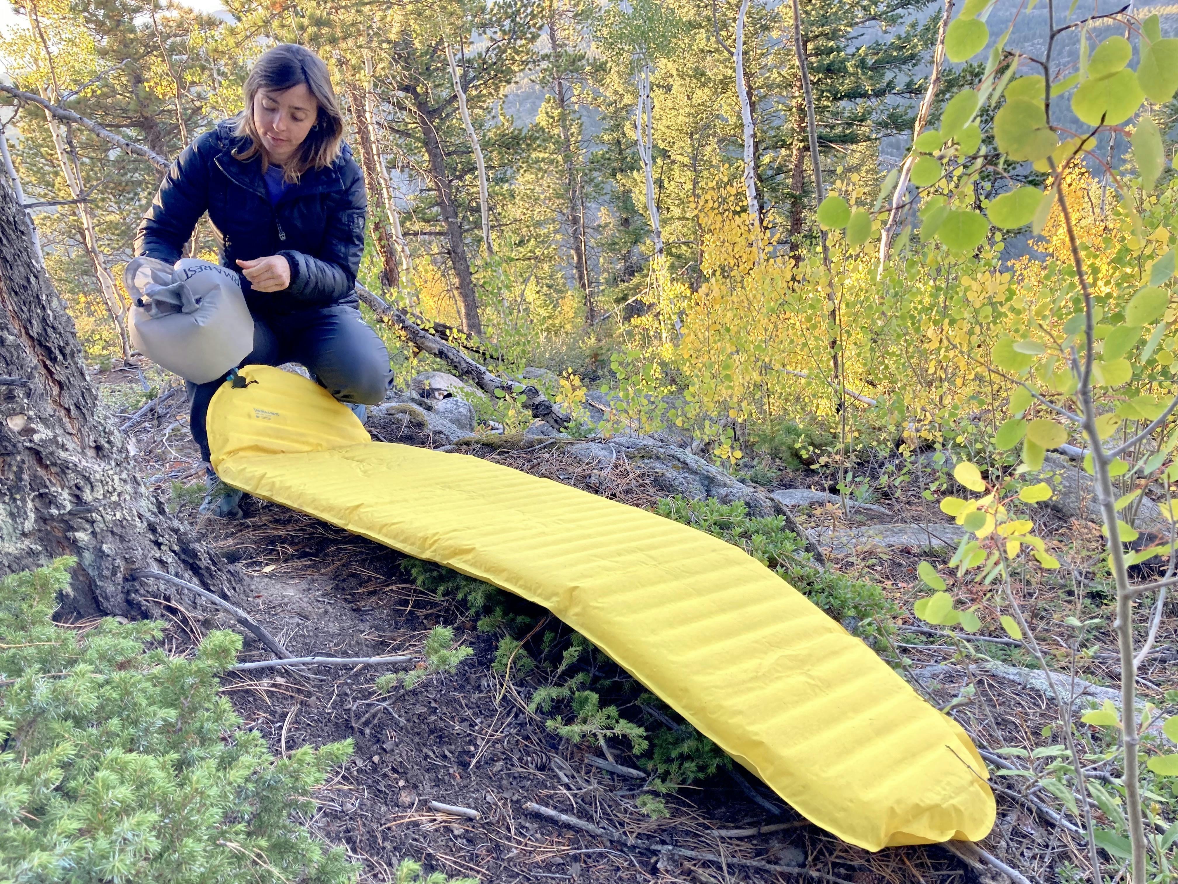 A camper inflating the Therm-a-Rest Neoair Xlite Sleeping Pad.