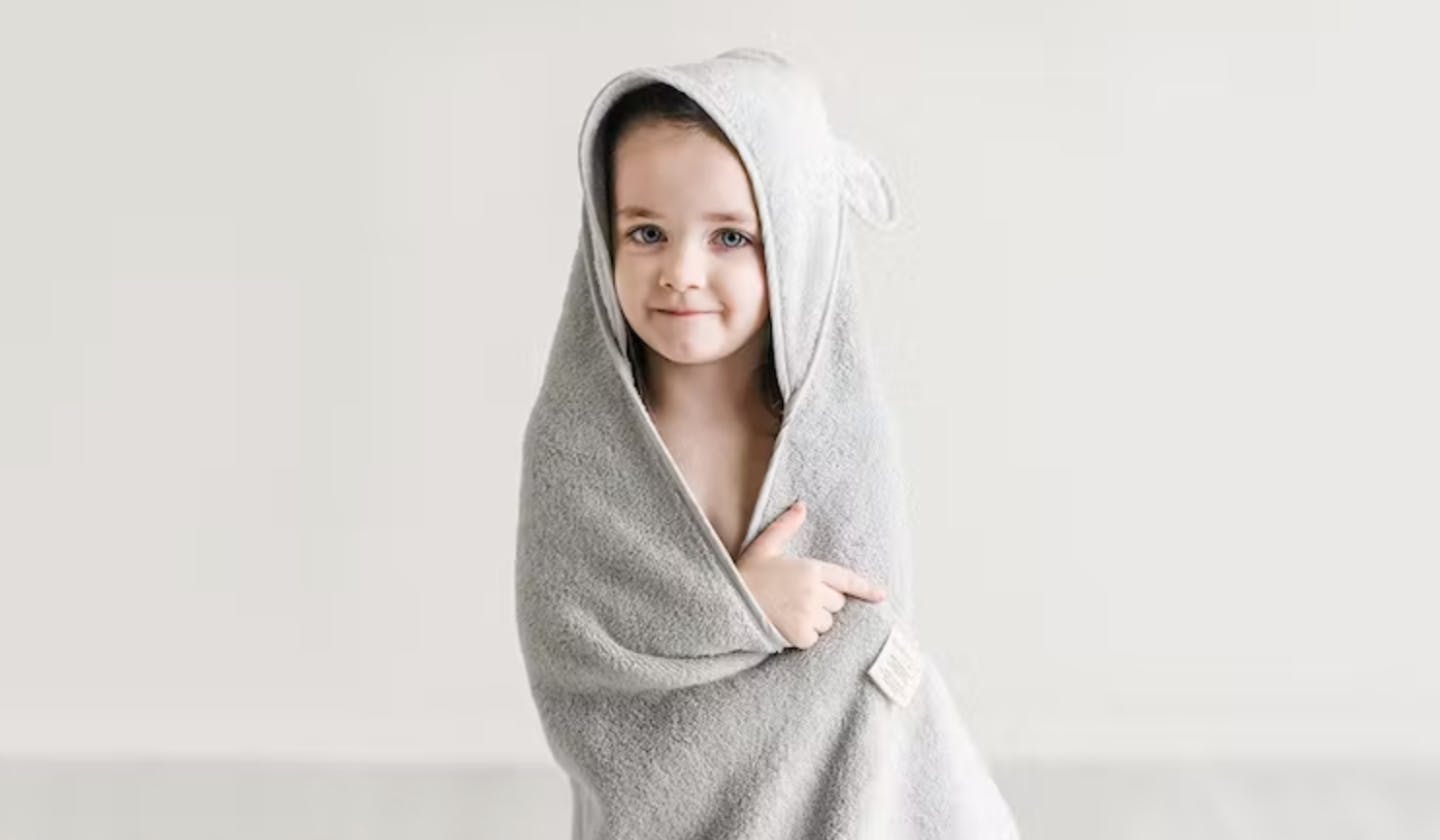 A child wearing a hooded towel.