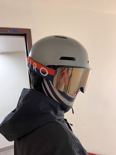 A skier indoors wearing the Giro Ledge MIPS Helmet.