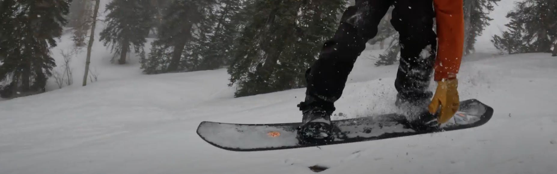 A snowboarder jumping with the 2023 Salomon Highpath snowboard