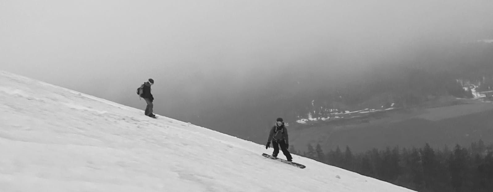 Two snowboarders on a snowy mountain.