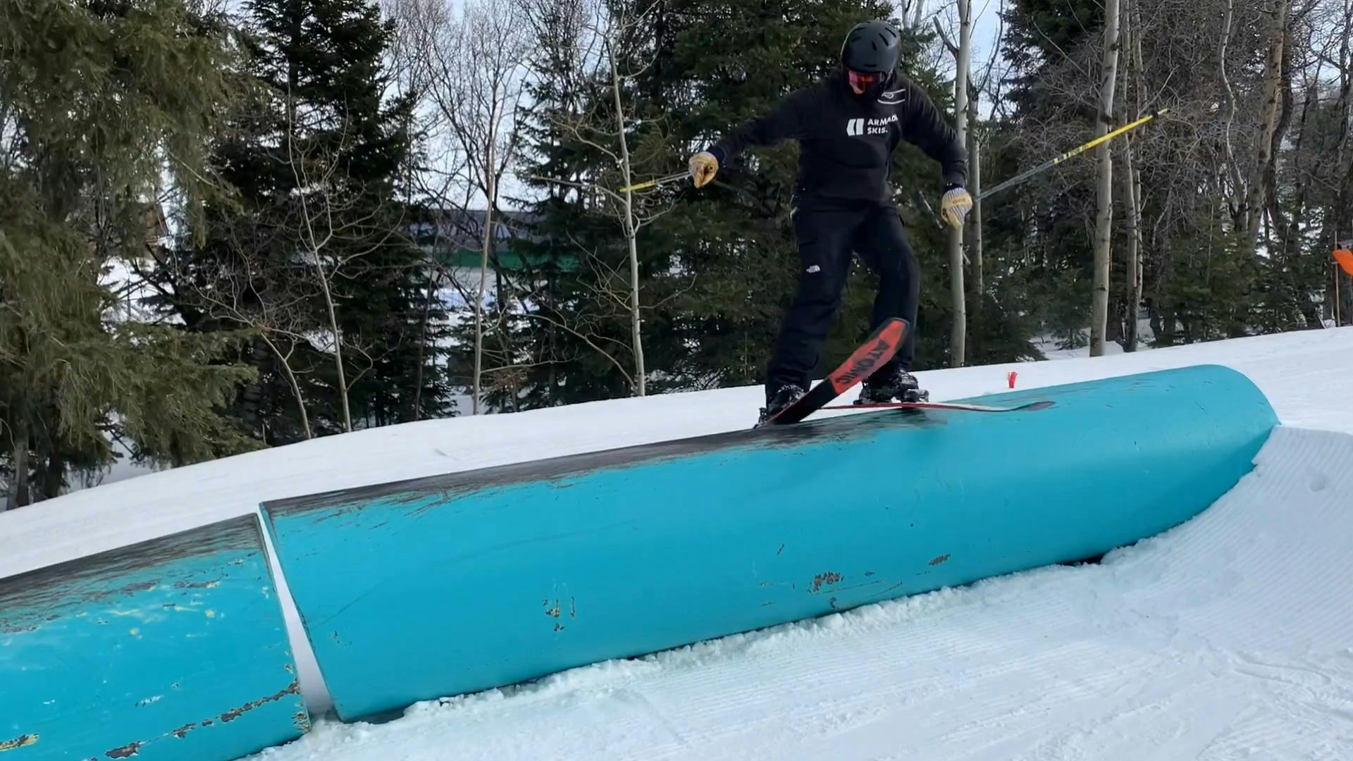 A skier jumping on a feature in a terrain park. 