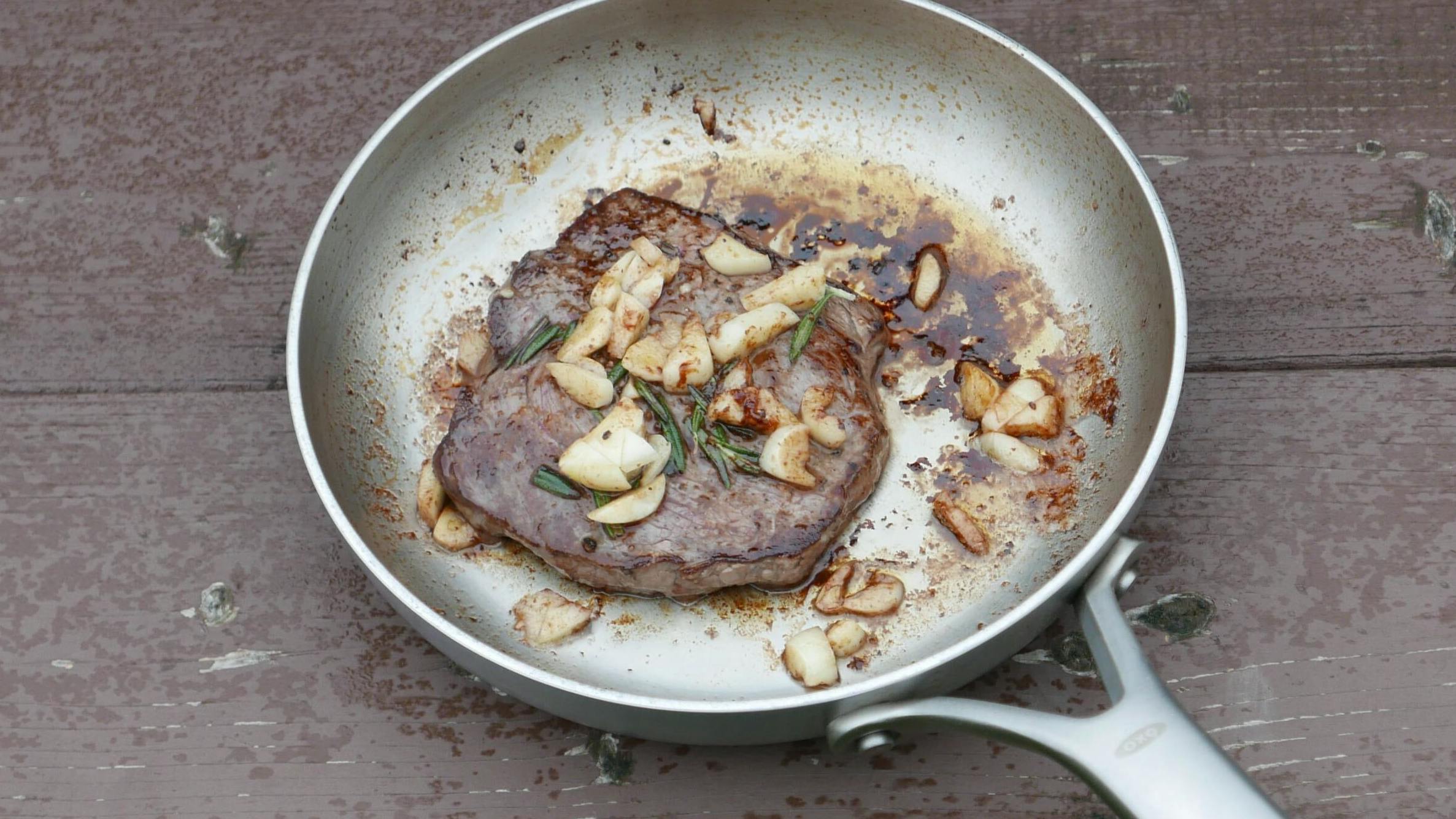 A pan-seared steak sits in the author's frying pan.