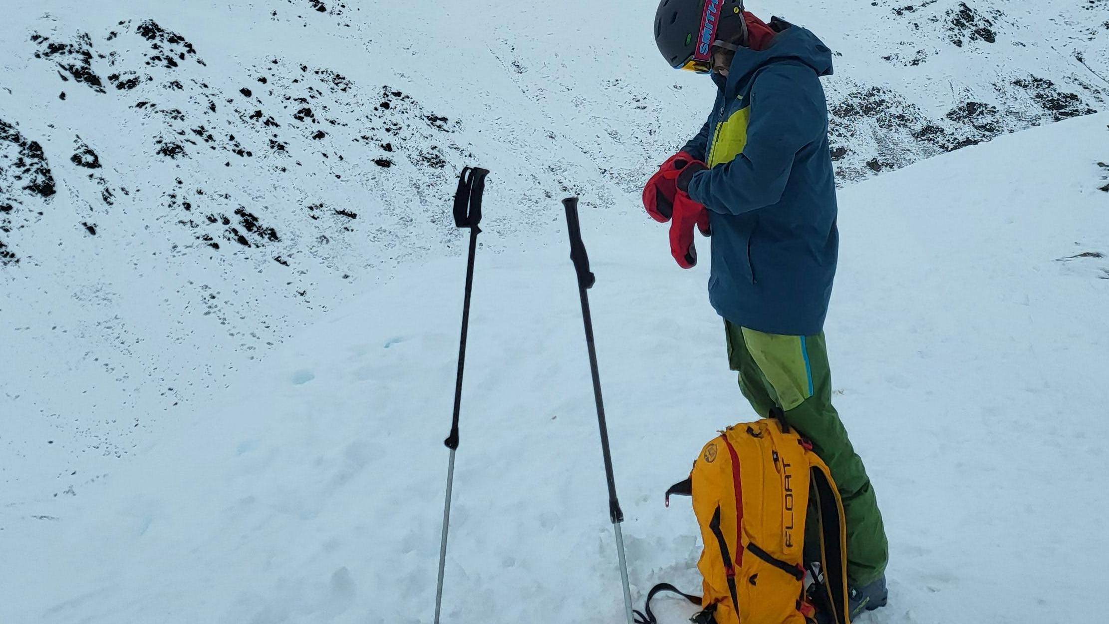 A skier with the Outdoor Research Women's Alti Mitts.