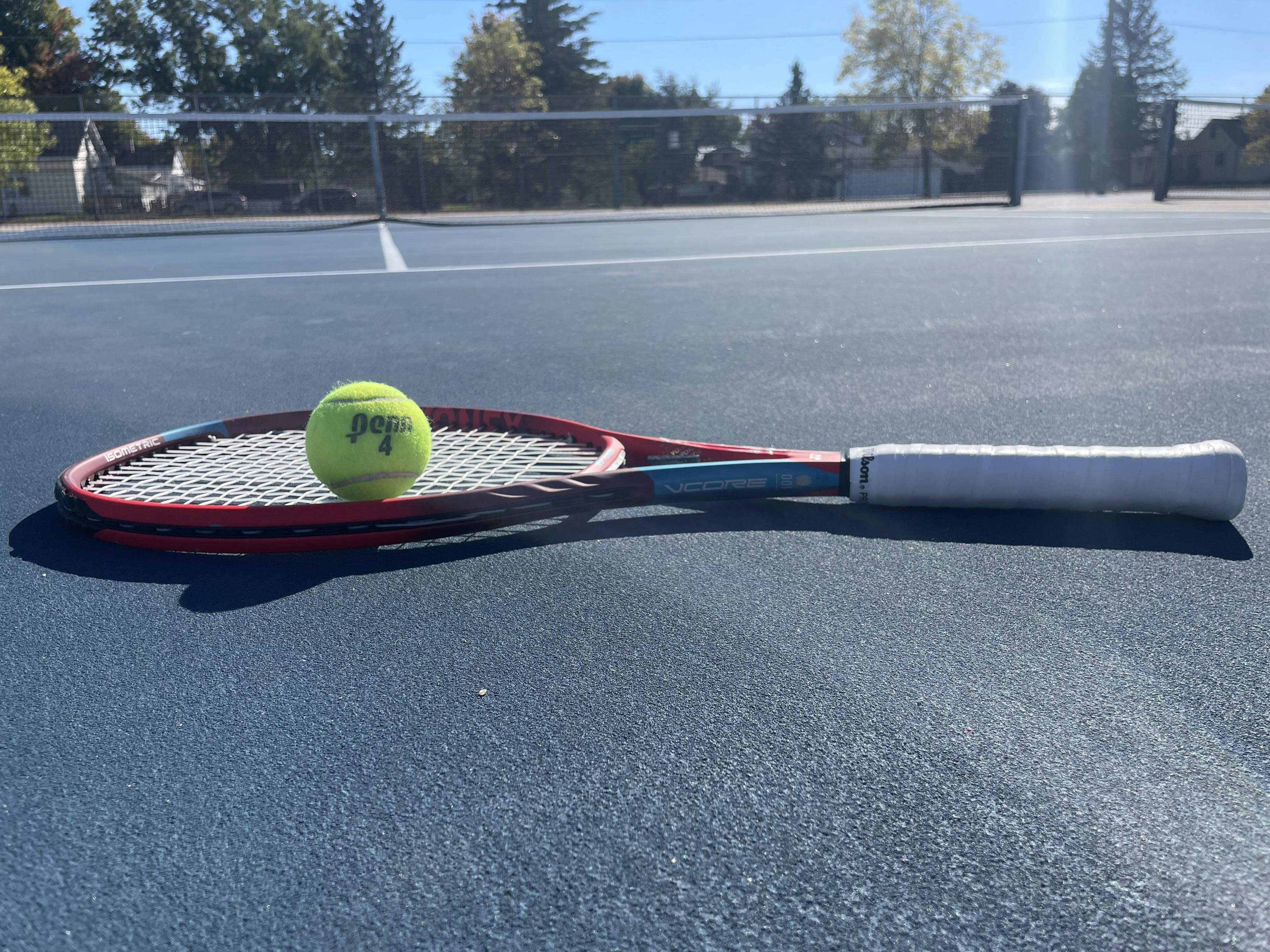 The Yonex VCore 100 Racquet on a tennis court.