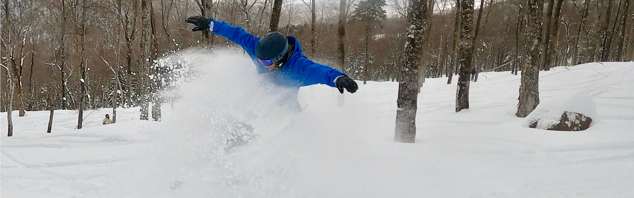 Curated expert Franco DiRienzo blasts through deep powder on his snowboard