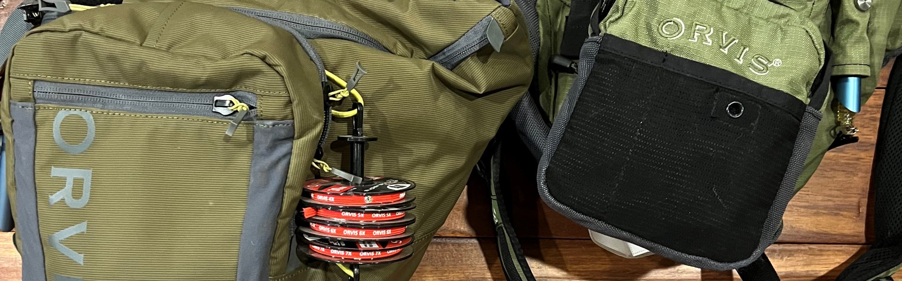 Two versions of the Orvis Sling Pack sitting next to each other. 