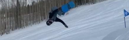 A man doing a flip on a snowboard.