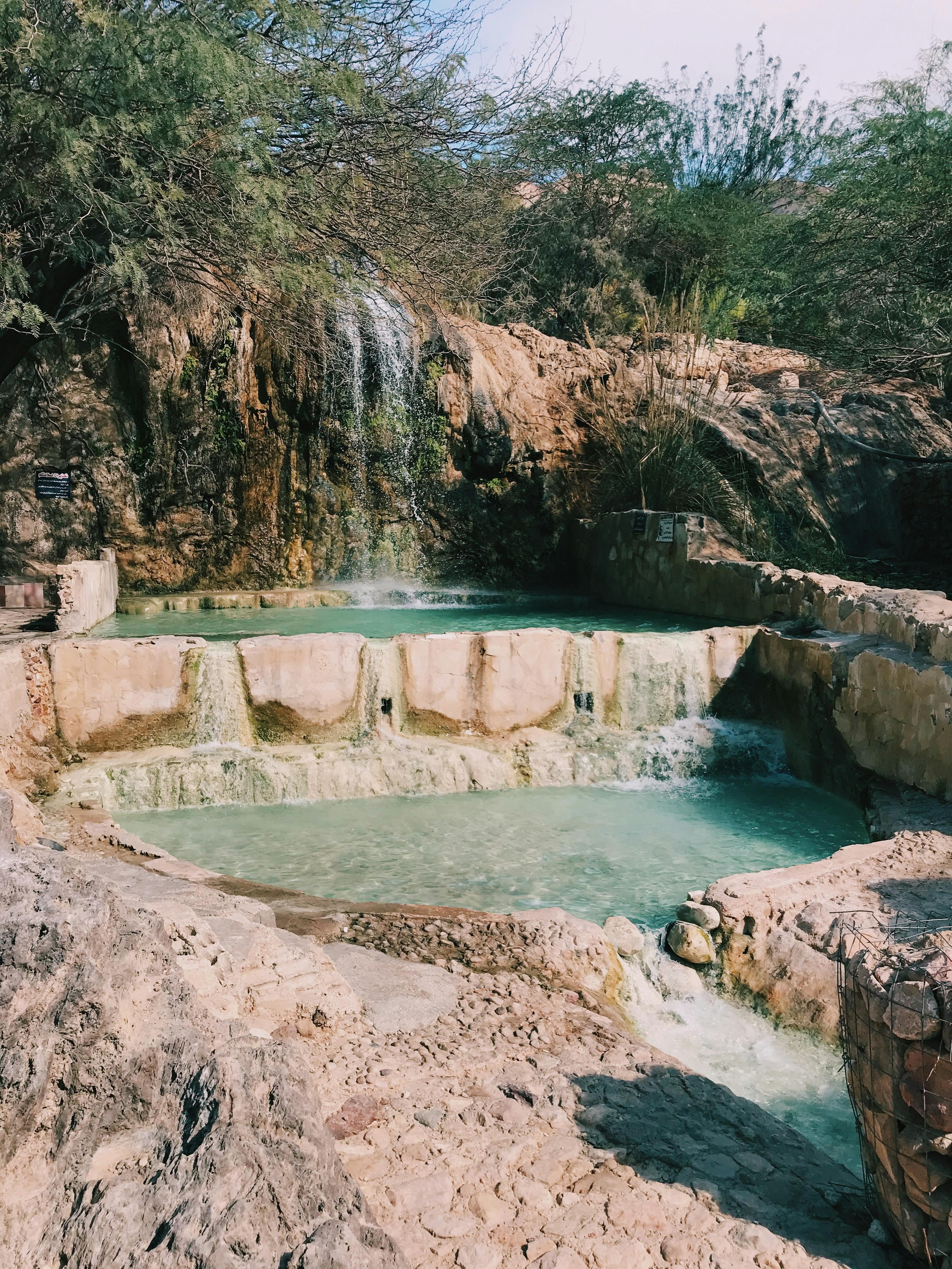 Image of hot springs with light blue water. 
