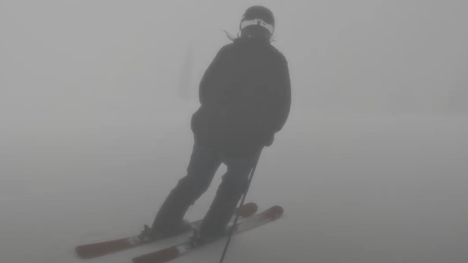 A skier carving down a mountain. 