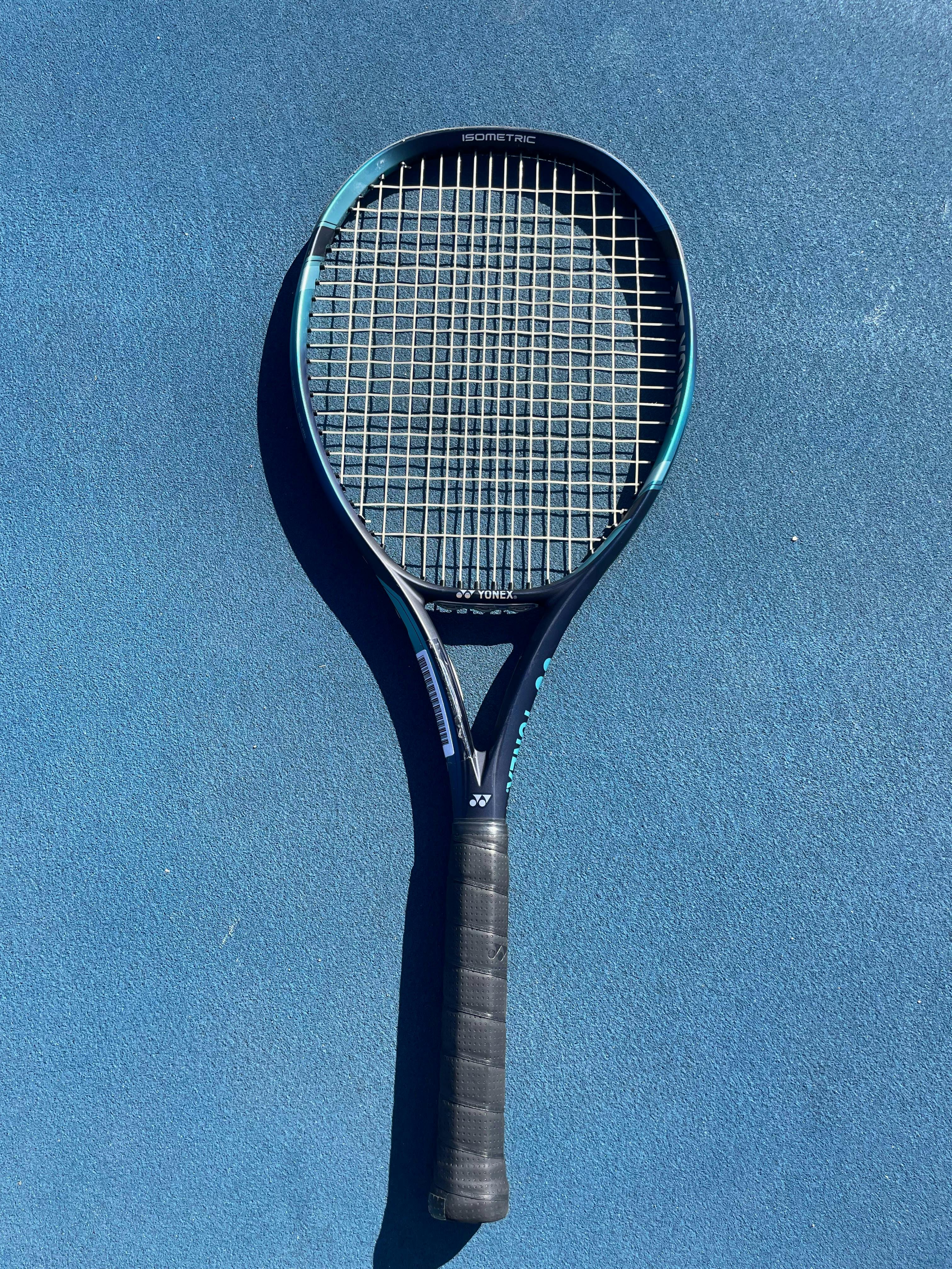 The Yonex EZone 100 Racquet on the ground. 