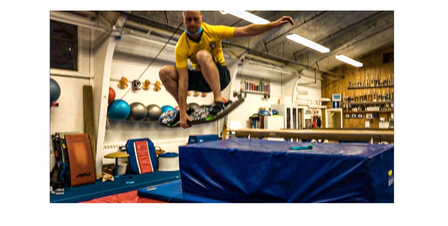A man does an indy grab on a trampoline.