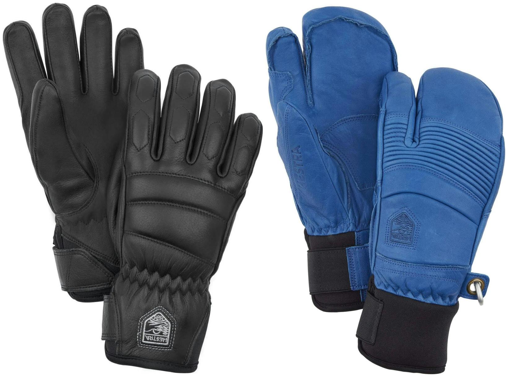 Two pairs of ski gloves. One is black while the other is blue and mitten-style