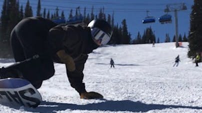 A snowboarder carving while using the Union Legacys.