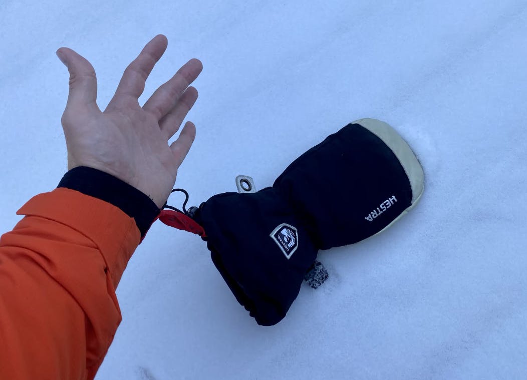 A hand with the Hestra Army Leather Heli Ski Mitt attached. 
