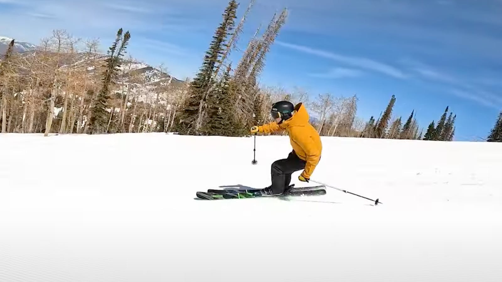 A skier carving down the mountain. 