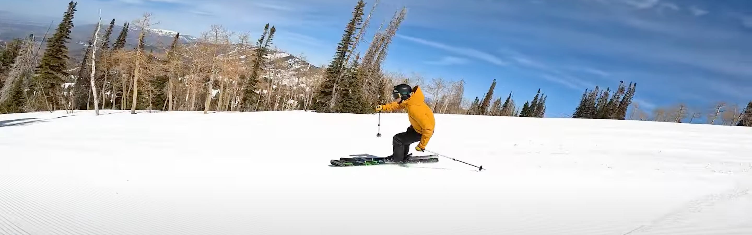 A skier carving down the mountain. 