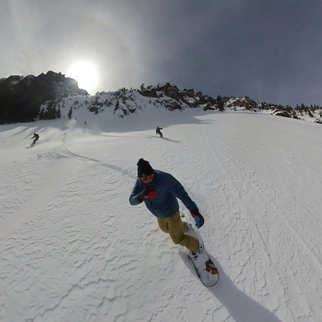 A snowboarder in the Dakine Men's Reach 20K Bib Pants.