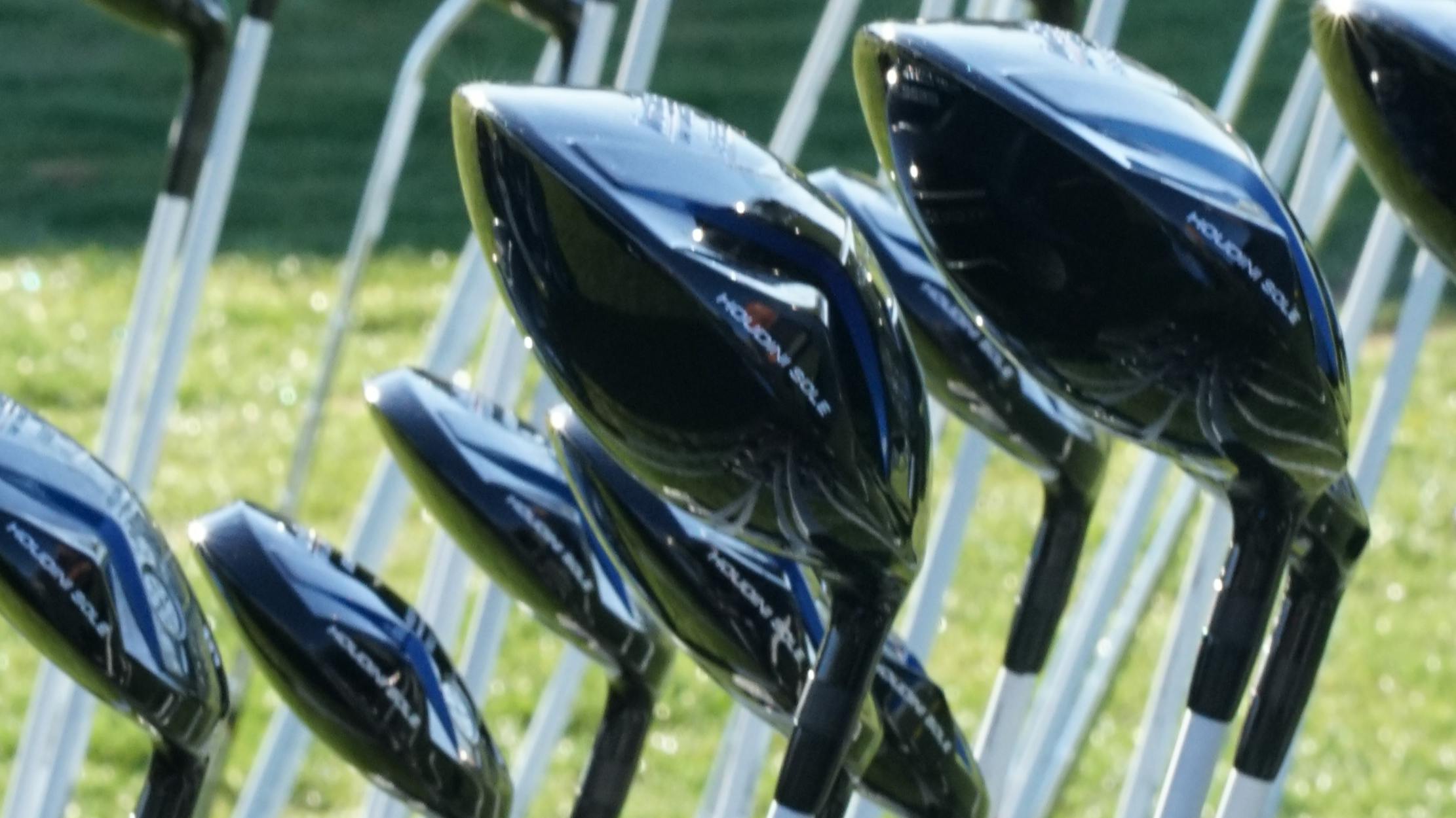 Golf clubs sitting in a rack