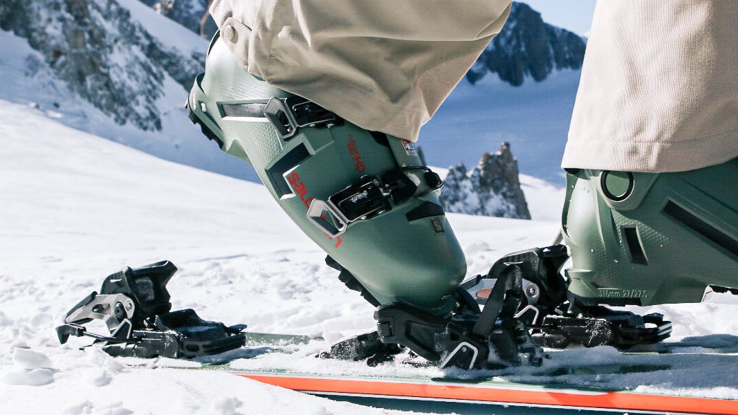 Close-up on the Salomon Shift bindings mounted on a ski in the snow.