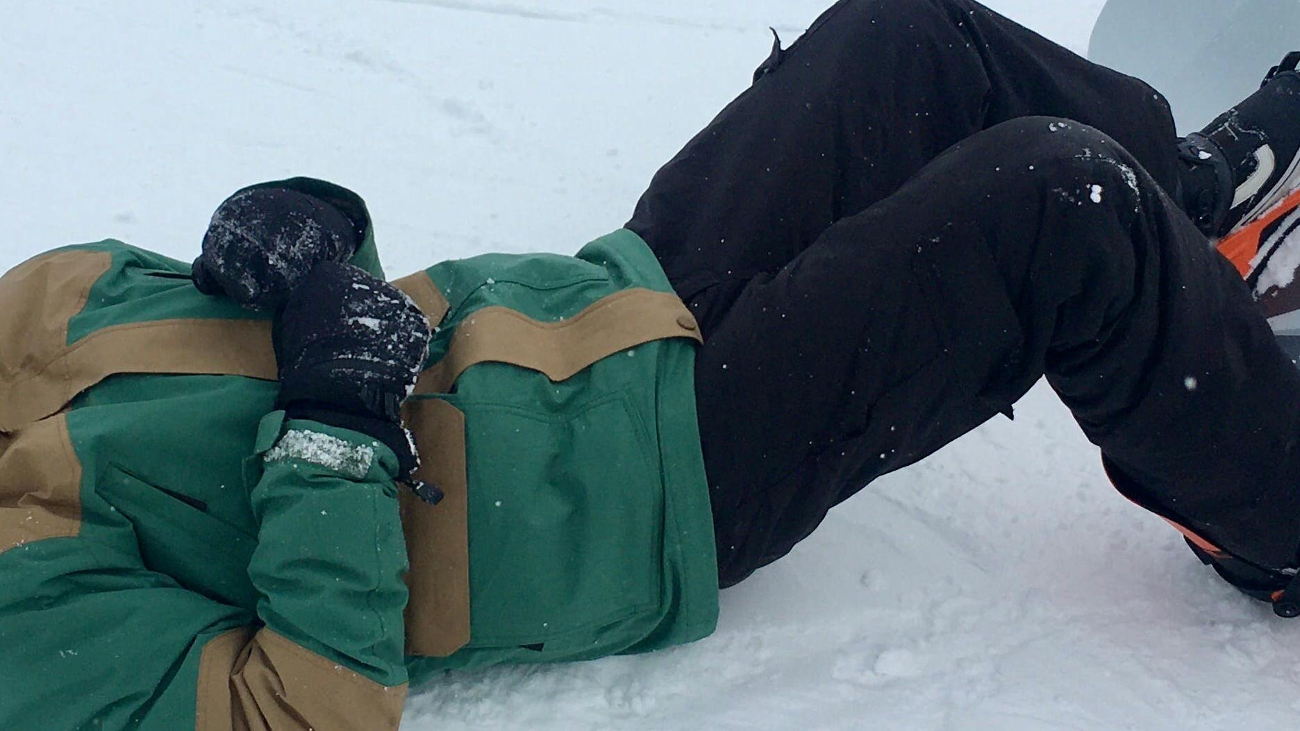 The author laying in the snow with his winter jacket on.
