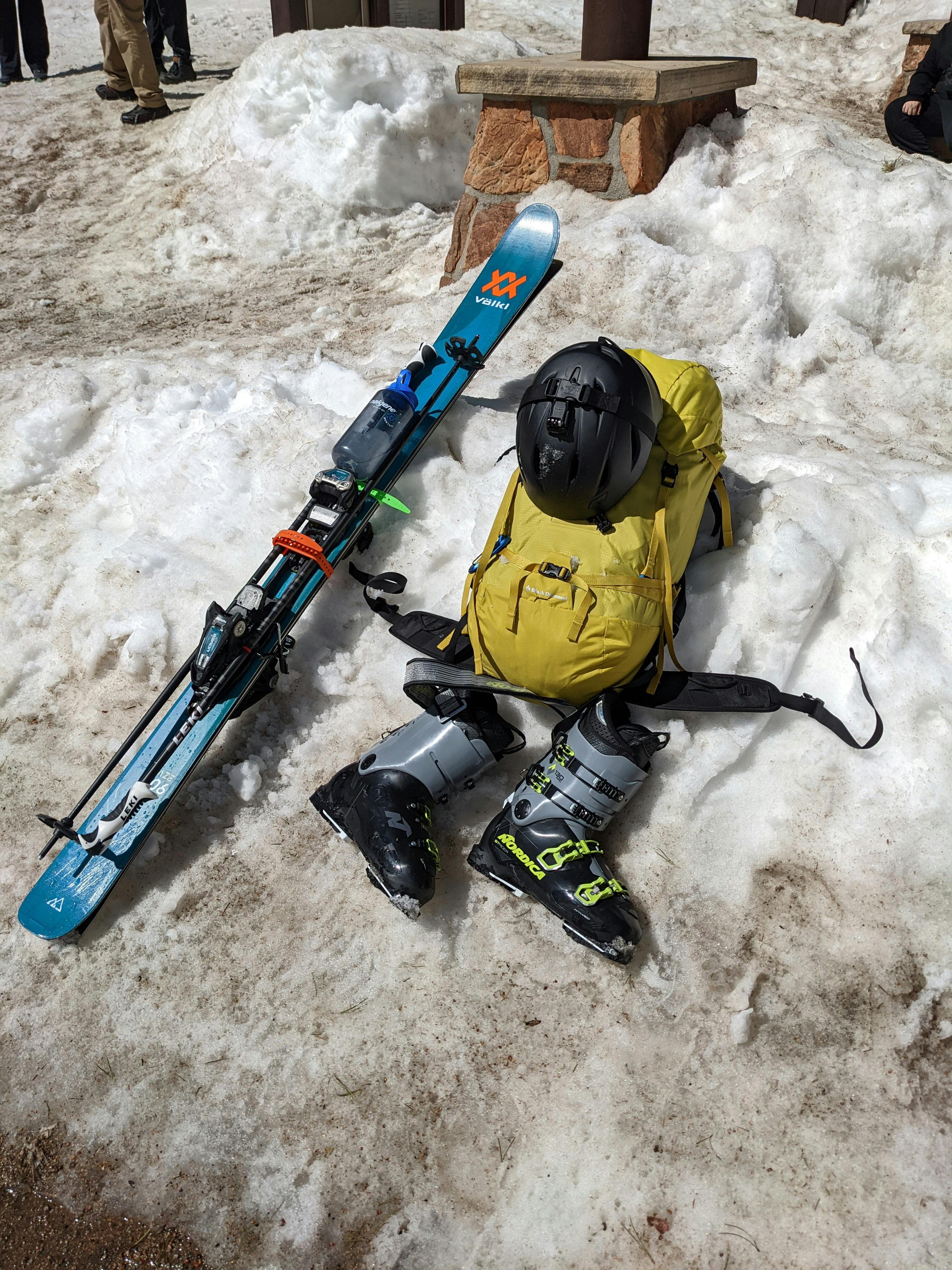 The Völkl Blaze 106 Skis · 2022 lying next to some boots and a backpack. 