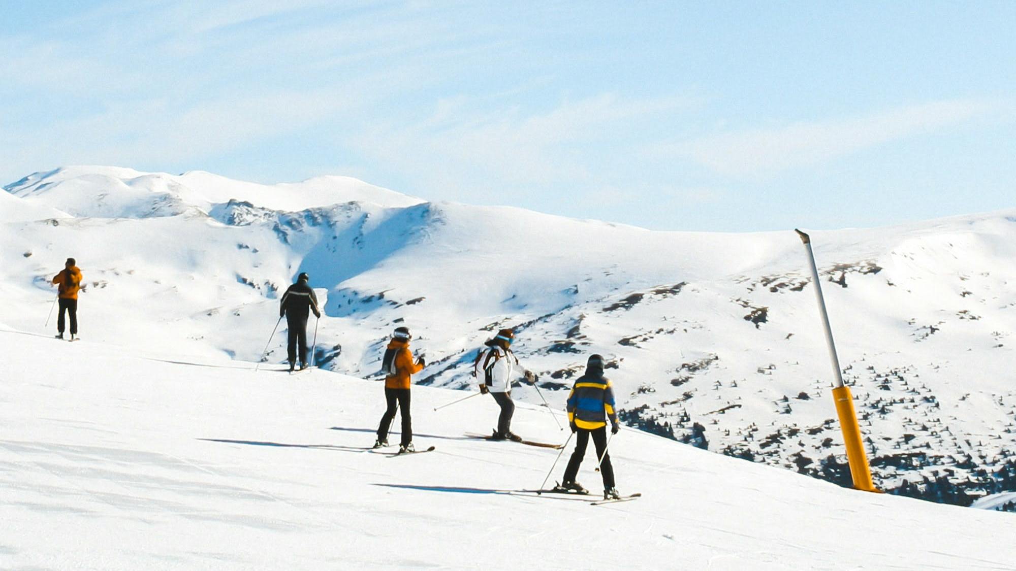 Several skiers on a ski hill.
