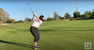 A screenshot from the YouTube video shows Armana pulling her club back before she swings.