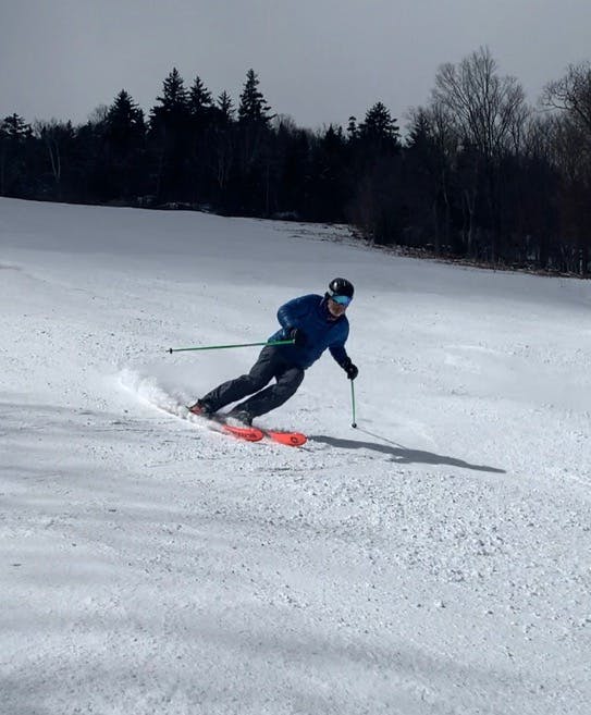 A skier makes a turn down a run.