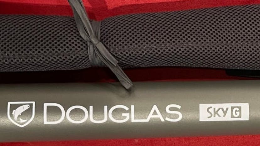 The Douglas SKY G Fly Rod in it's case laying on a table.