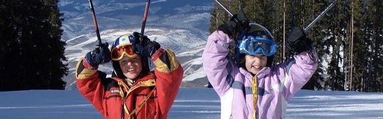 Curated expert Peter Reichheld with his sister wearing skis on a ski slope when they were kids
