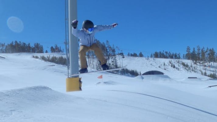 Man in the air during a snowboard jump.