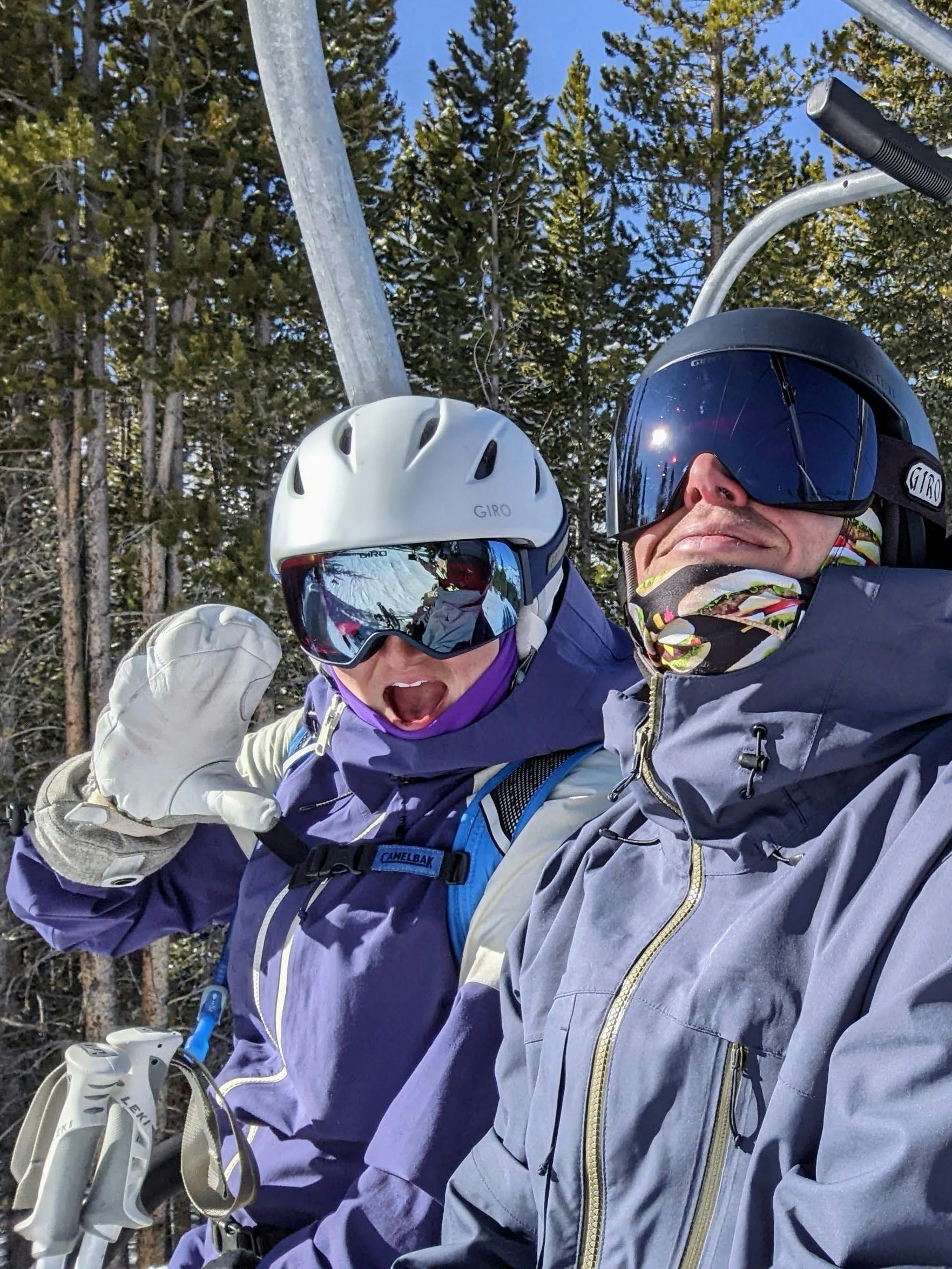 Two skiers on a chairlift. 