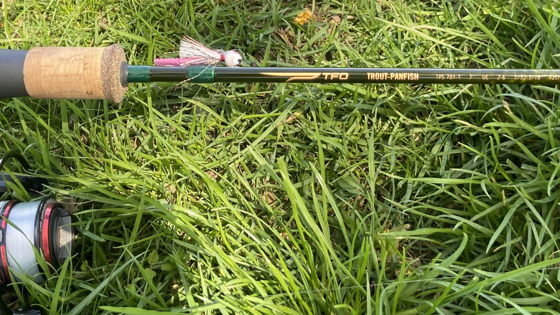 The Temple Fork Outfitters Trout-Panfish Rod lies in the grass.