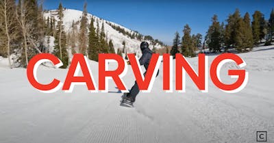 A snowboarder carving on a mountain with the words "carving" overlayed.