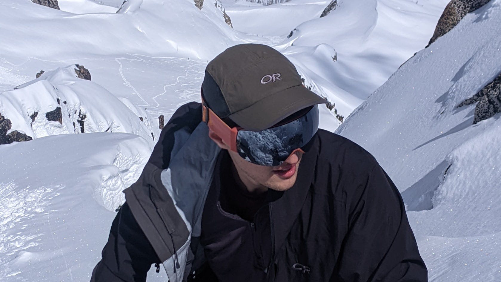 A skier hiking up a snowy area in the Smith I/O MAG Goggles.