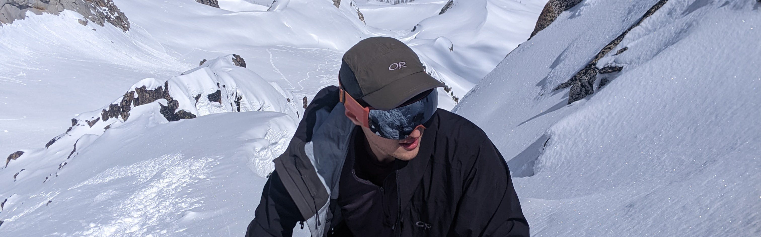 A skier hiking up a snowy area in the Smith I/O MAG Goggles.