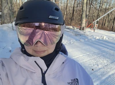A selfie of a woman wearing a snowboard helmet and goggles and the The North Face Women's Ceptor Shell Jacket.