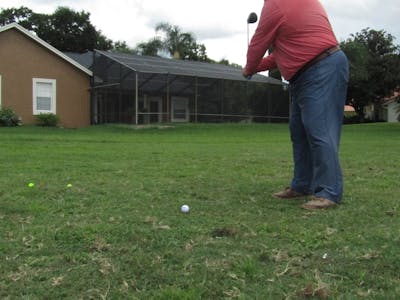 A man taking a swing with a golf club.