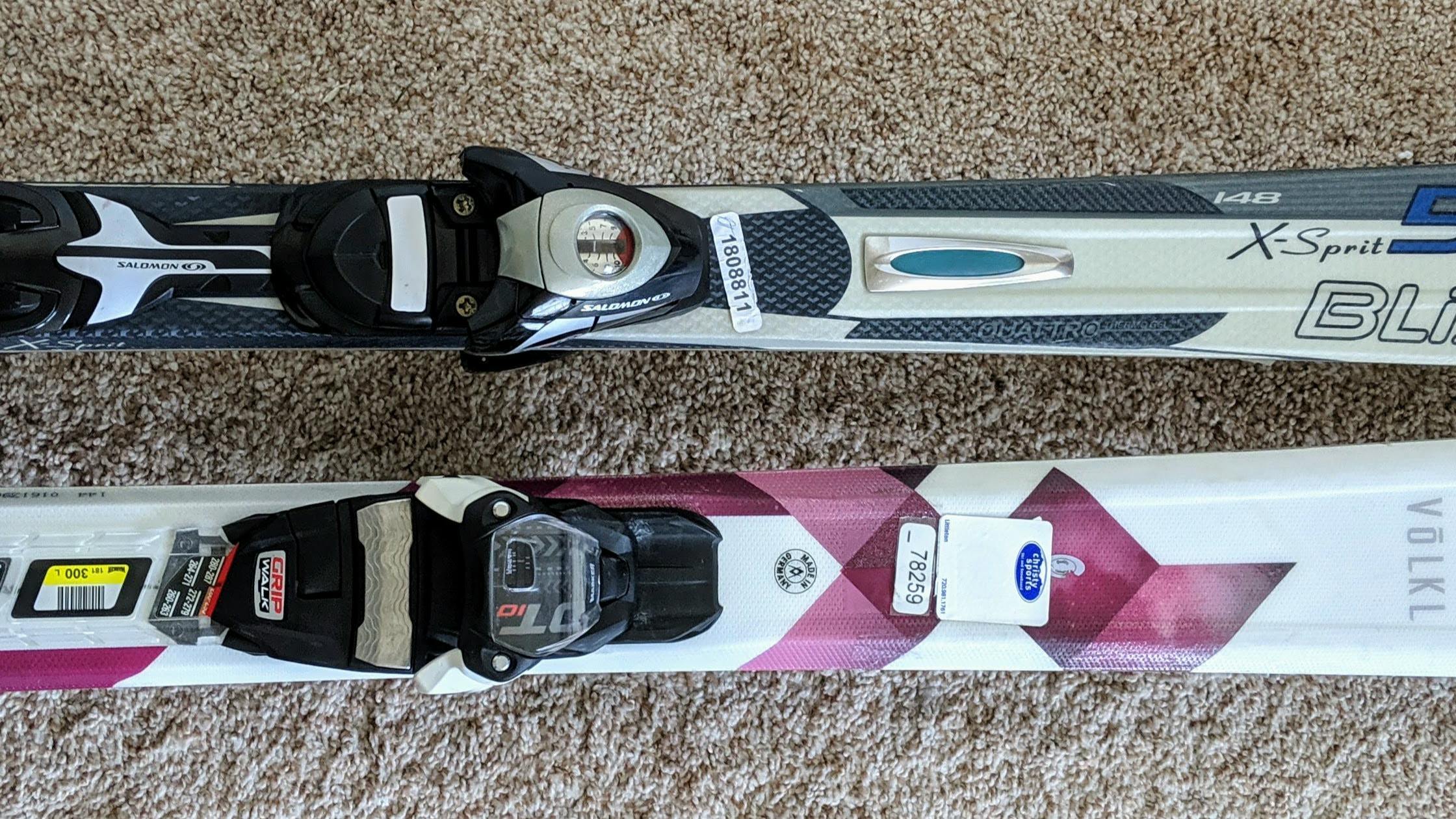 Two pairs of skis sitting next to each other. 
