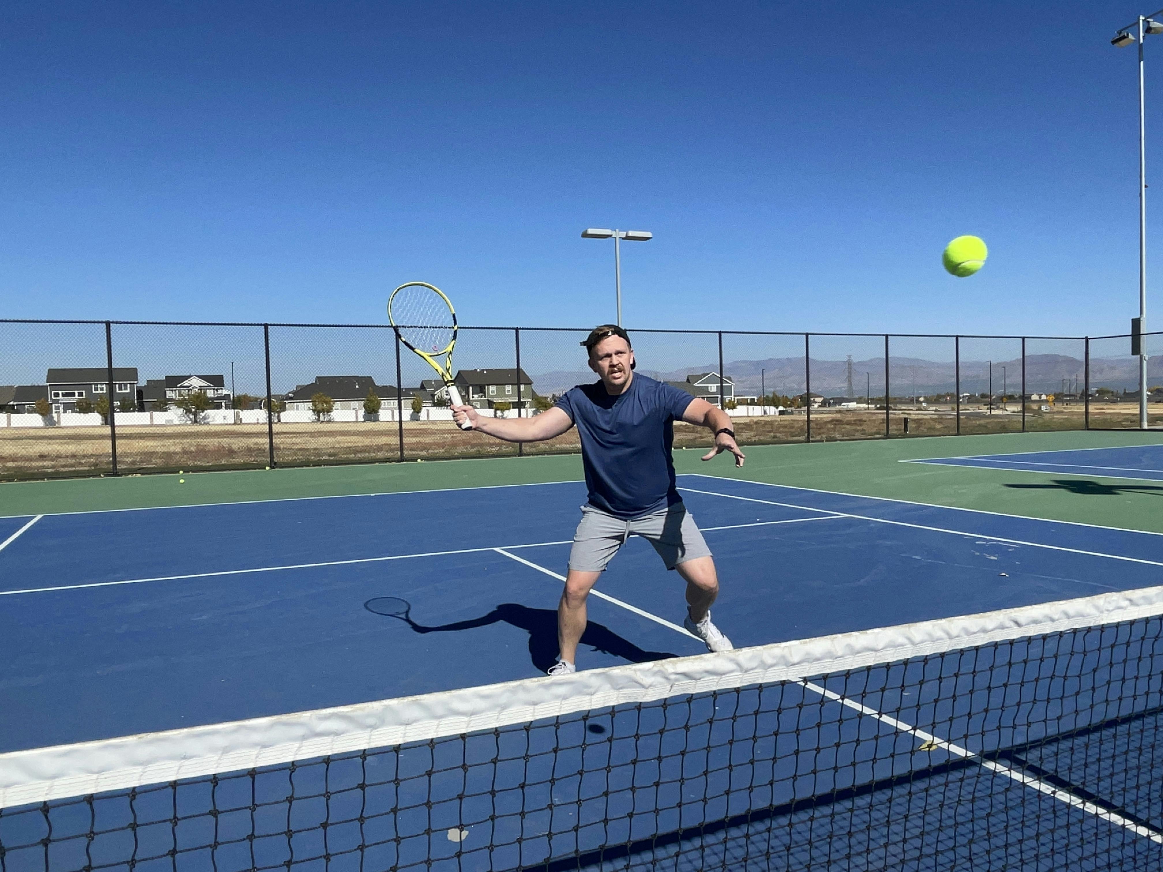 A man hitting a tennis ball with the Babolat Pure Aero 100 Racquet · Unstrung
