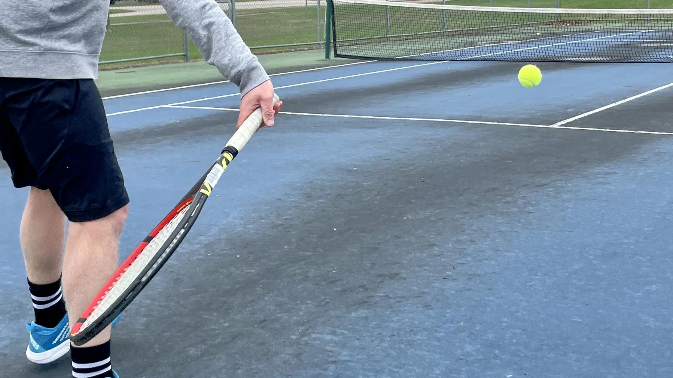 A tennis player using the  Volkl V-Cell 8 315g Racquet · Unstrung.