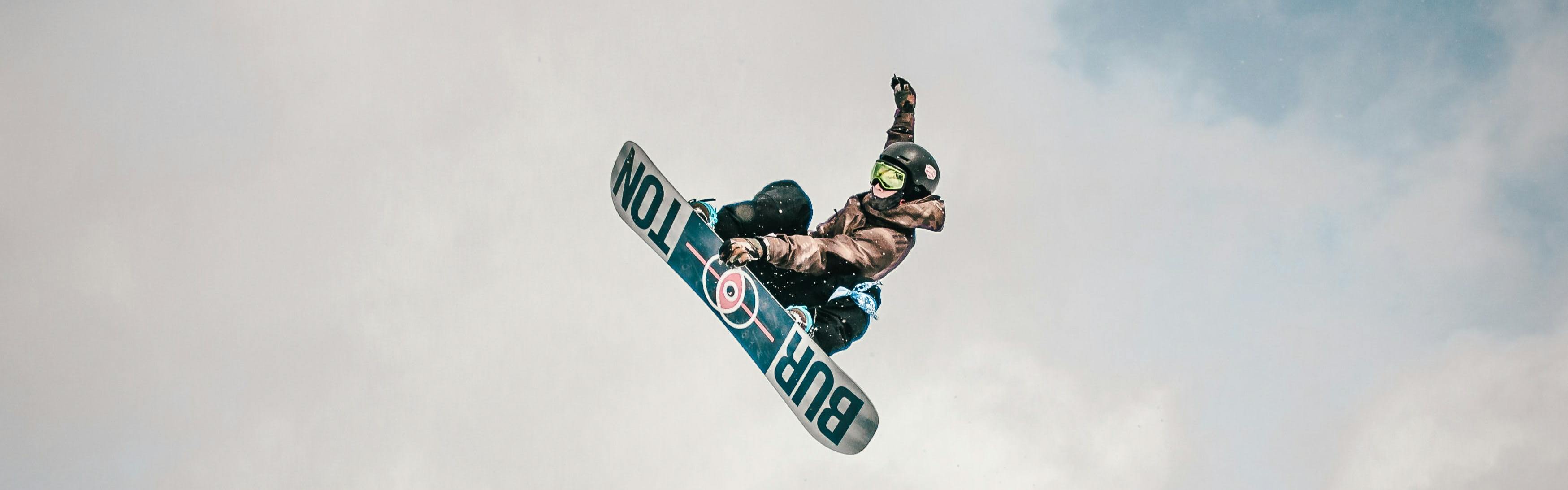 Snowboarder doing a jump on a Burton board.
