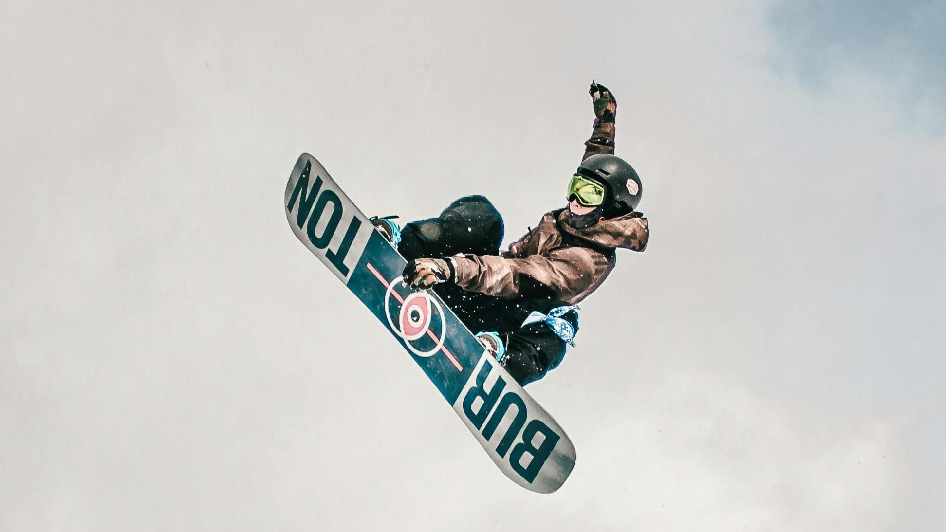 Snowboarder doing a jump on a Burton board.