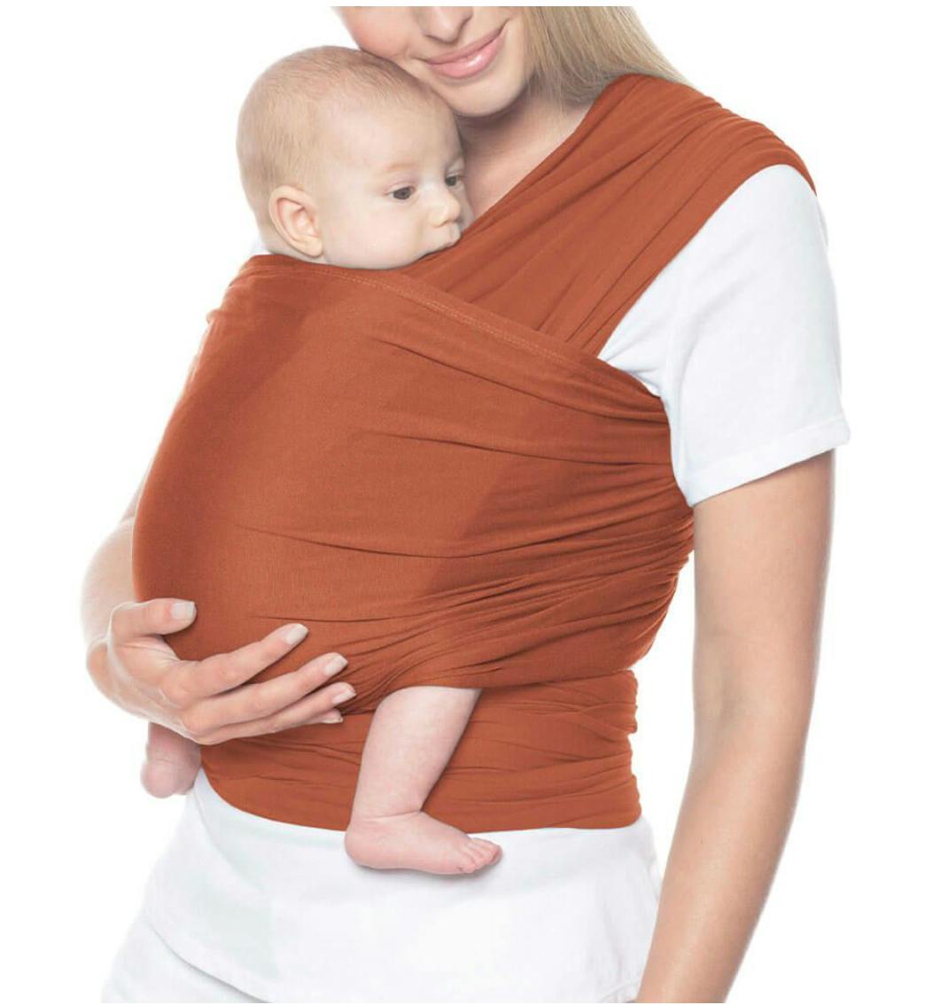 Woman using the Ergobaby Aura Baby Wrap.