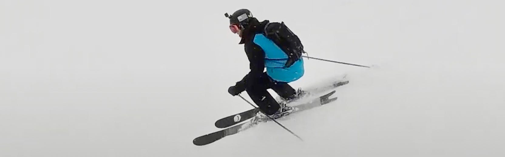 Curated expert Robbie M. skiing down a slope with Line Sakana skis