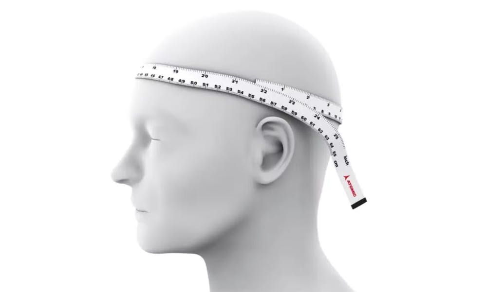 A simple graphic of a head with a ¾ profile showing a tape measure around the circumference of the head. 