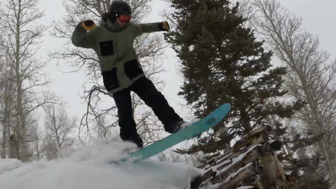 Curated Snowboard Expert Spencer Storck jumping with the 2023 Burton Daily Driver snowboard